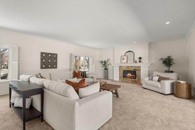 living area featuring crown molding, a fireplace, recessed lighting, light colored carpet, and baseboards