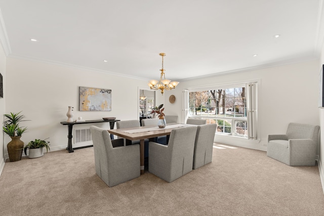 dining room with light carpet, crown molding, baseboards, and a notable chandelier