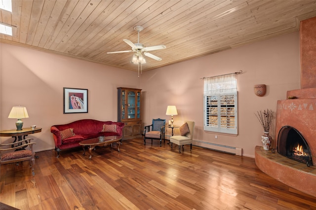 living area with wood ceiling, a baseboard radiator, wood finished floors, and a lit fireplace