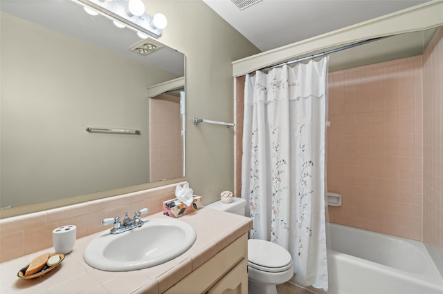 bathroom with toilet, shower / tub combo, and vanity