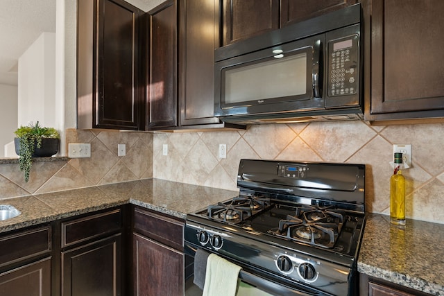 kitchen featuring dark brown cabinetry, black appliances, and backsplash