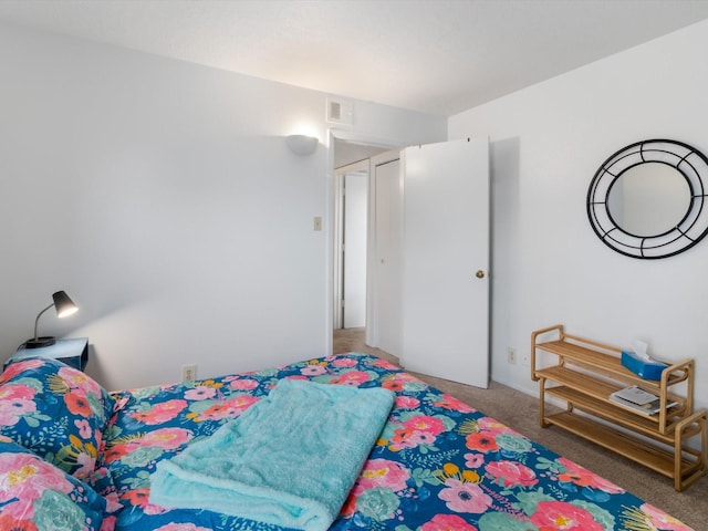 bedroom with visible vents and carpet