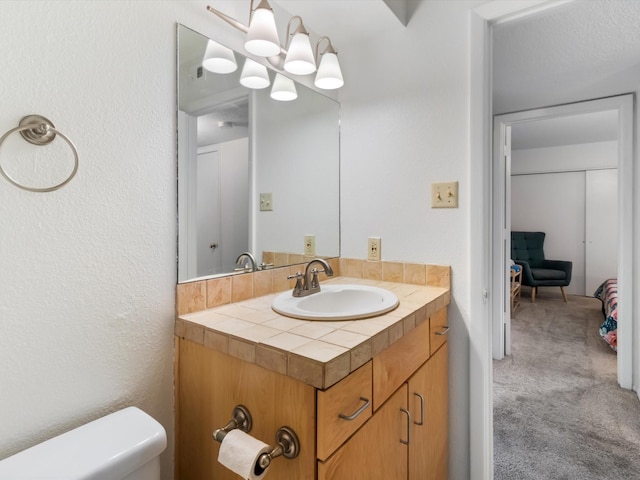 941 Calle Mejia Unit 715, Santa Fe, NM 87501 - half bath with vanity, toilet, and a chandelier