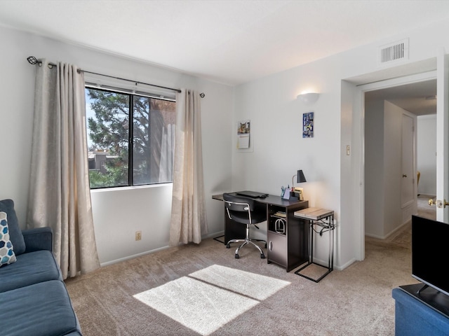 carpeted office space featuring visible vents and baseboards