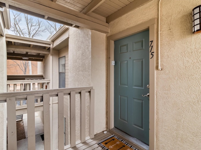 entrance to property featuring stucco siding