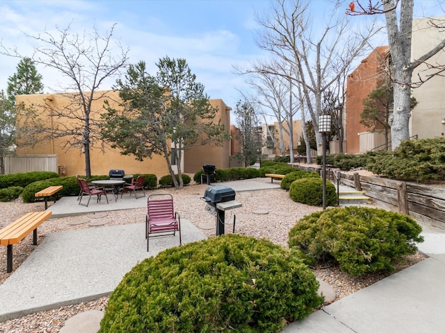 view of property's community with a patio and fence