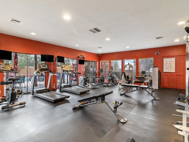 exercise room featuring visible vents, recessed lighting, and a textured ceiling