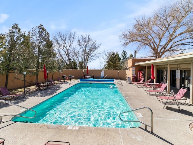 pool featuring a patio area and fence