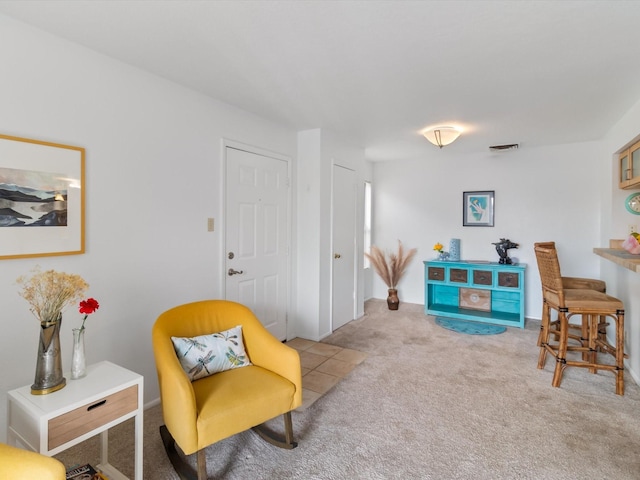 living area featuring carpet flooring