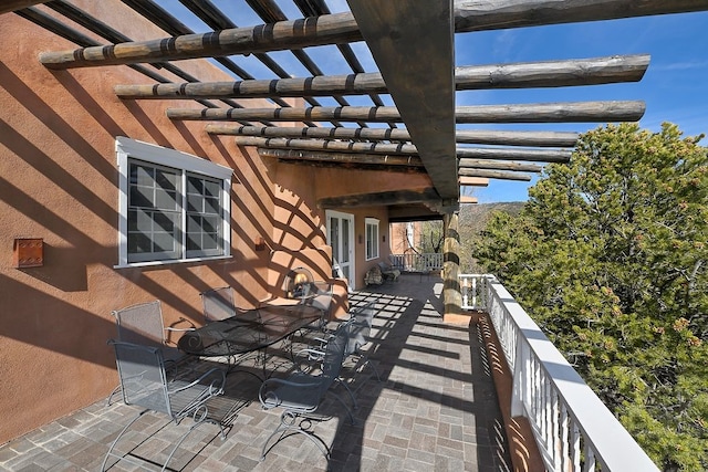 view of patio featuring a balcony and a pergola