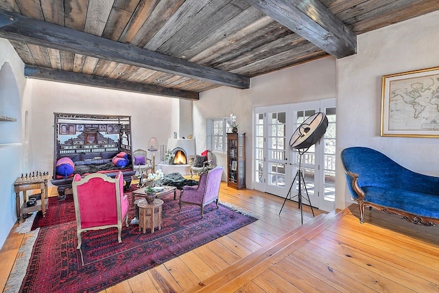 dining space featuring wood ceiling, french doors, wood-type flooring, and beam ceiling