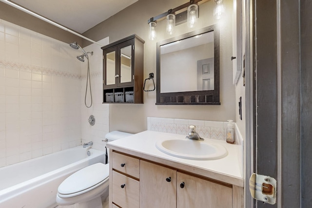 full bath featuring shower / bath combination, vanity, toilet, and backsplash