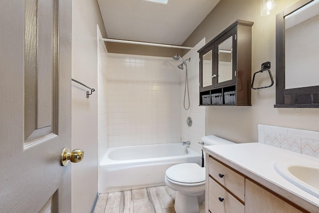 full bathroom with toilet, washtub / shower combination, wood finished floors, and vanity