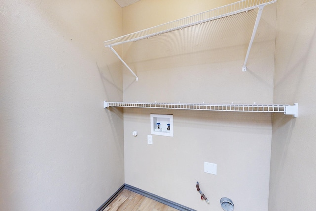 washroom with laundry area, wood finished floors, gas dryer hookup, and hookup for a washing machine