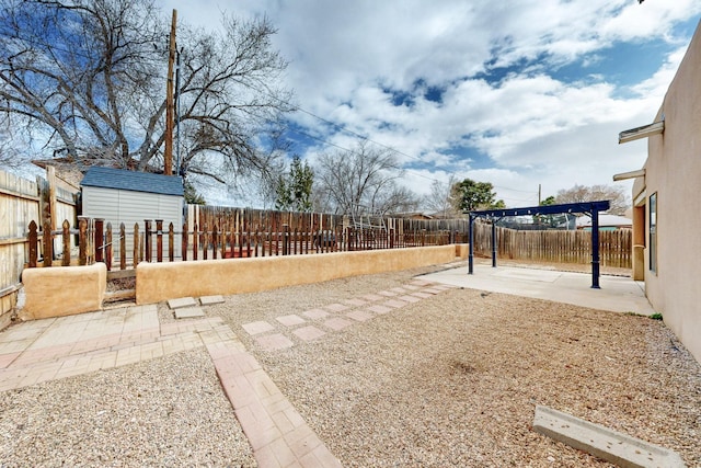 view of yard featuring a fenced backyard, a shed, an outbuilding, and a patio