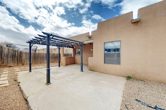 view of patio featuring fence and a pergola