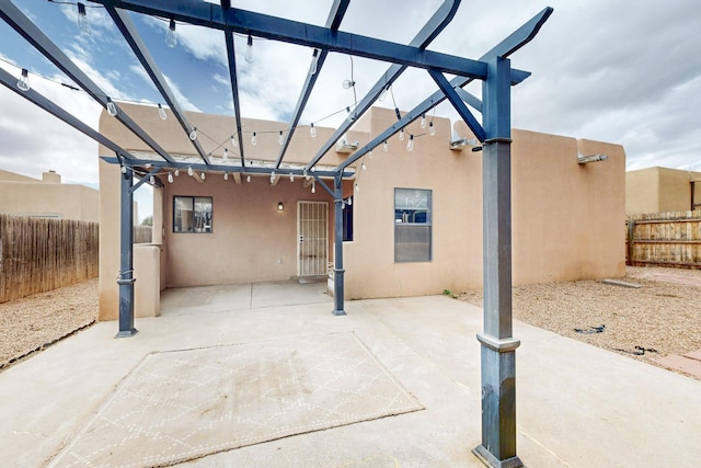 view of patio featuring fence and a pergola