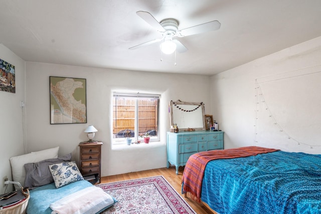 bedroom with light wood-style floors and ceiling fan