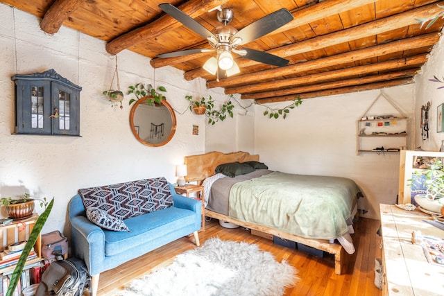 bedroom featuring wood ceiling, hardwood / wood-style floors, and beamed ceiling