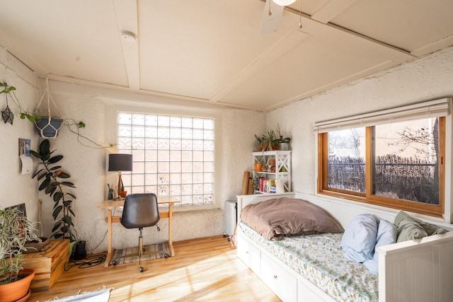 bedroom featuring radiator and wood finished floors