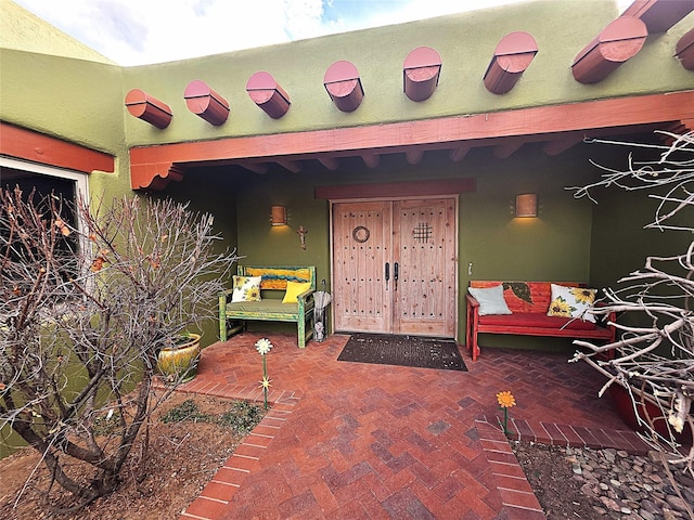 doorway to property featuring stucco siding