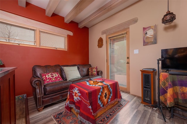 living room with beam ceiling and wood finished floors