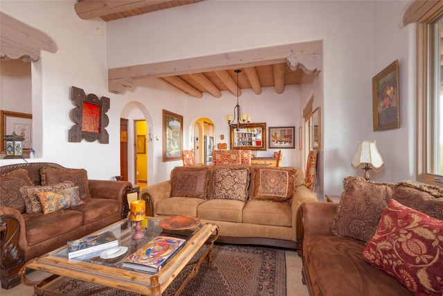 living area featuring wooden ceiling, a notable chandelier, arched walkways, and beam ceiling