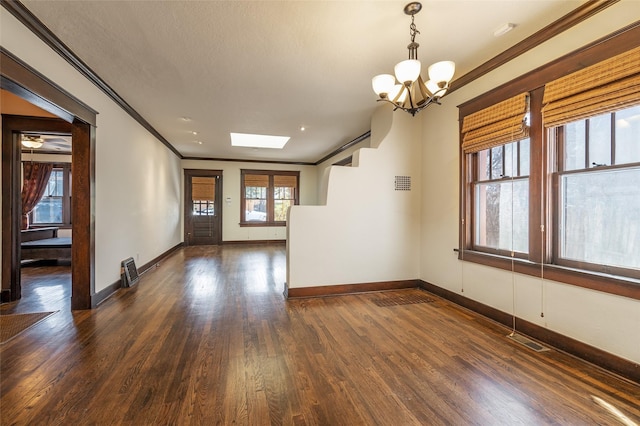 empty room with baseboards, visible vents, dark wood-style flooring, and ornamental molding