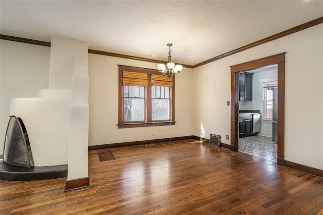 unfurnished dining area with dark wood-style floors, ornamental molding, and an inviting chandelier