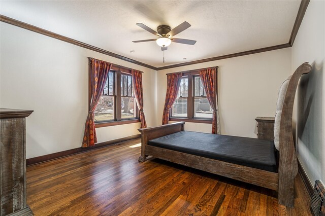 bedroom with a ceiling fan, baseboards, wood finished floors, and ornamental molding