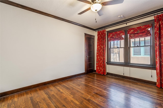 unfurnished room featuring a ceiling fan, crown molding, baseboards, and wood finished floors