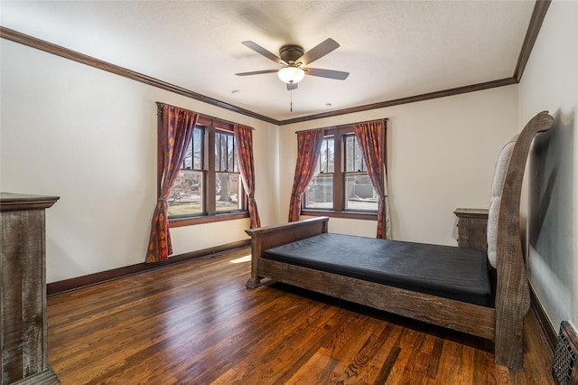 bedroom featuring ceiling fan, baseboards, ornamental molding, and wood finished floors