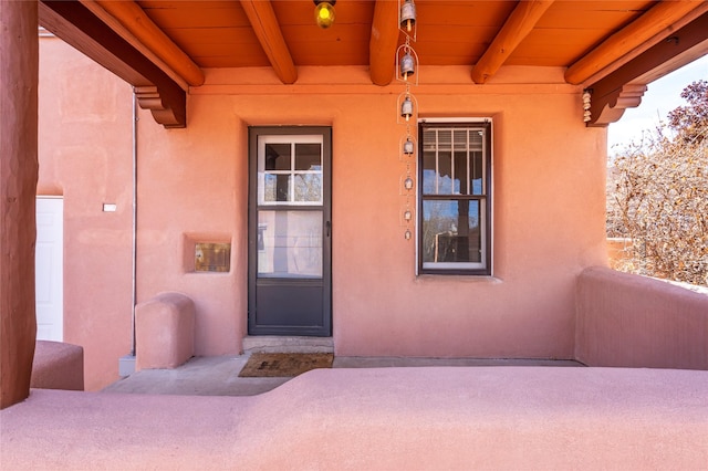 doorway to property with stucco siding