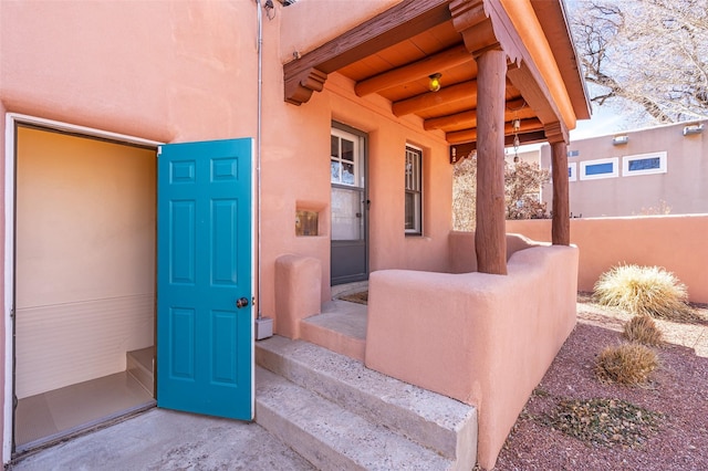 view of exterior entry featuring stucco siding