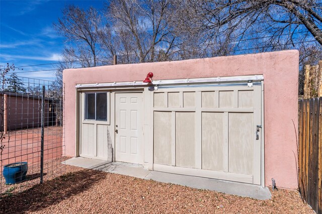 view of outdoor structure featuring an outbuilding and fence