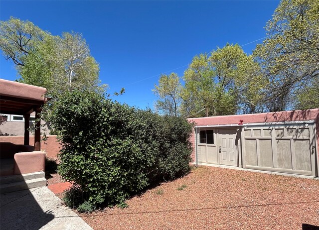 view of outdoor structure featuring an outbuilding and fence