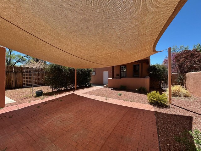 view of front of property featuring stucco siding and fence