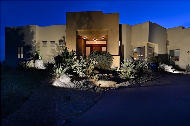 pueblo revival-style home with stucco siding