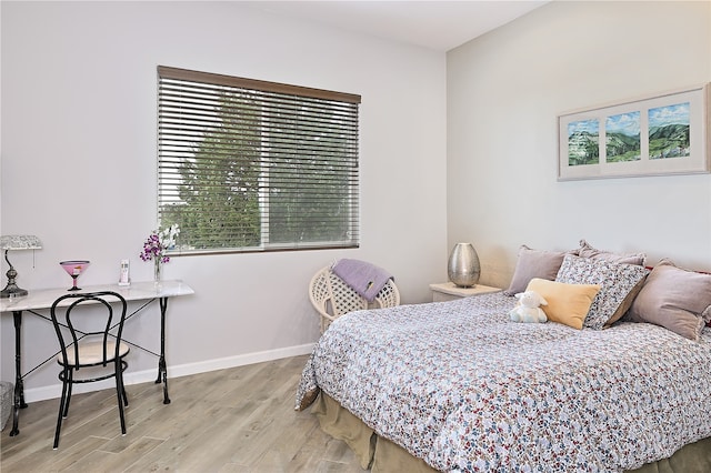 bedroom featuring wood finished floors and baseboards