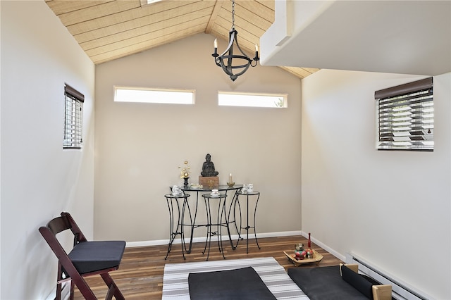 dining room with a notable chandelier, wood finished floors, baseboards, lofted ceiling, and baseboard heating