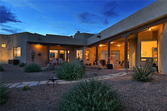 back of property with a patio area and stucco siding