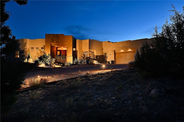 exterior space featuring an attached garage and stucco siding