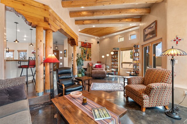 living room with beam ceiling, plenty of natural light, recessed lighting, and concrete floors