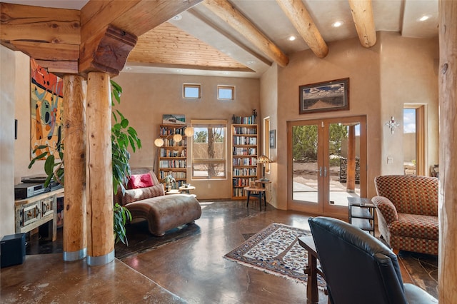 living area with beam ceiling, plenty of natural light, and french doors