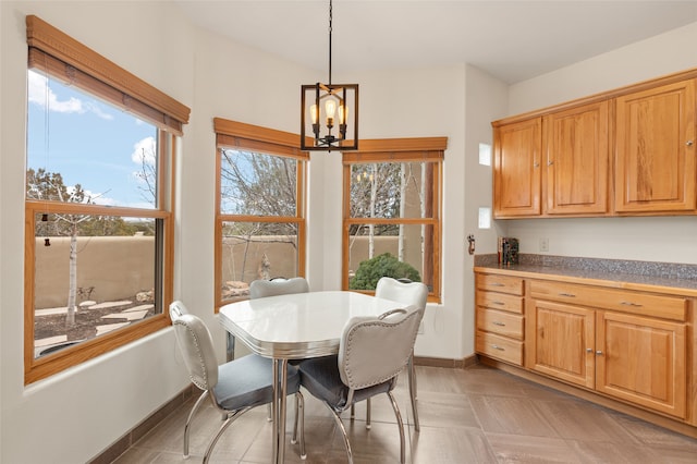 dining room with baseboards and an inviting chandelier