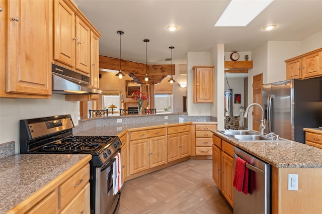 kitchen with under cabinet range hood, light brown cabinets, stainless steel appliances, and a sink