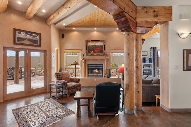 living room with decorative columns, recessed lighting, french doors, a glass covered fireplace, and beamed ceiling