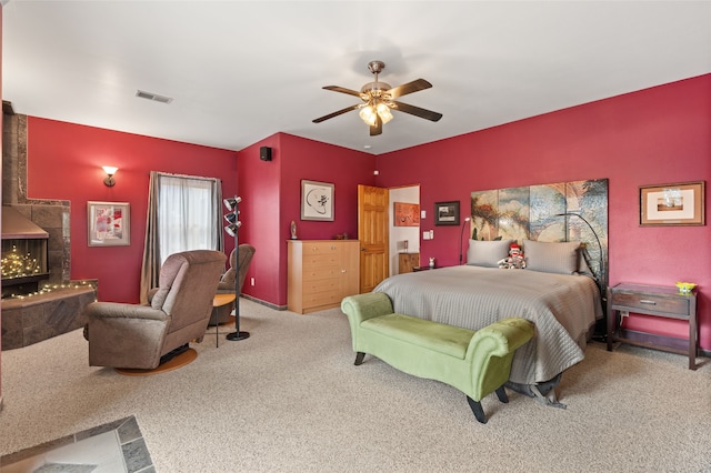 bedroom with carpet flooring, a ceiling fan, and visible vents