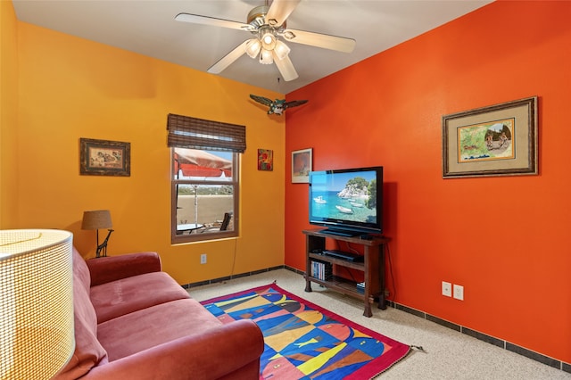 carpeted living room with baseboards and ceiling fan