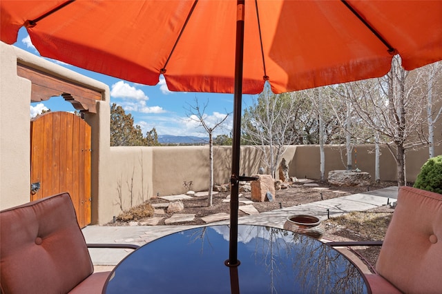 view of pool featuring a patio area, a gate, and a fenced backyard